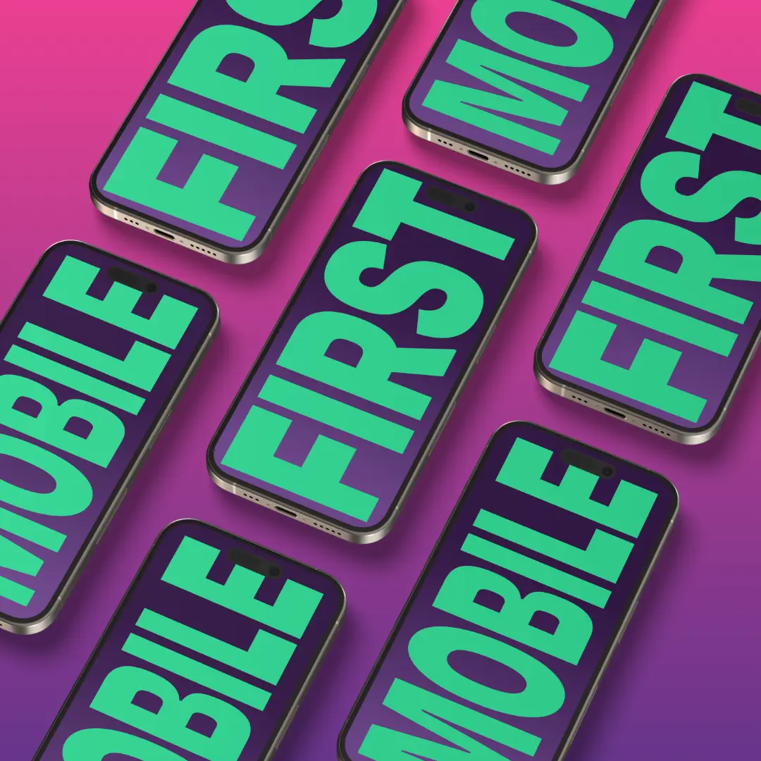 Multiple smartphones displaying the text "MOBILE FIRST" across a purple and pink background.